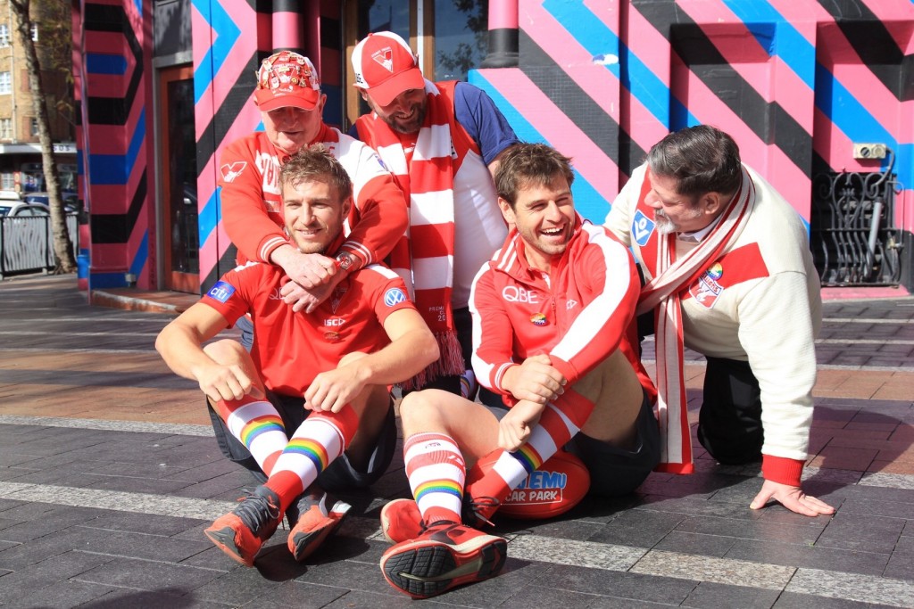 Sydney Swans players Kieren Jack (L) and Nick Smith feel the love from the Rainbow Swans members. Photo: Supplied/Rainbow Swans